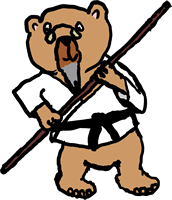 Kuma Sensei holding a Bo (staff) in ready stance.